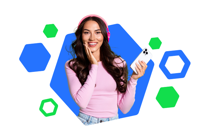 A young woman with long hair wears bright pink headphones and a matching long-sleeve top while holding a white smartphone. She appears to be listening to audio, with one hand touching the headphones and the other holding the phone. The background features a modern blue hexagonal shape with additional blue and green hexagons floating around. The overall composition feels playful and tech-focused, emphasizing digital lifestyle and music streaming.